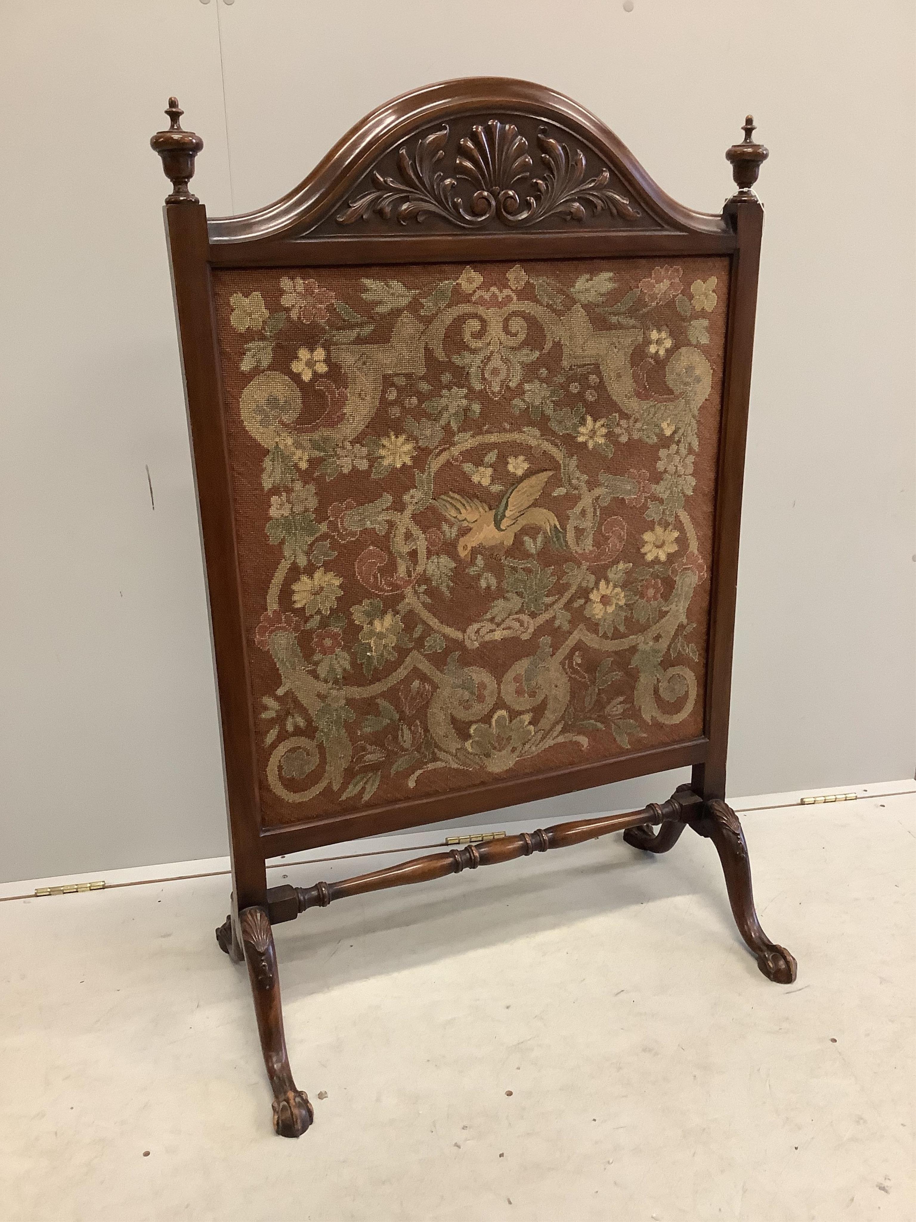 An early 20th century carved mahogany fire screen with tapestry panel, width 76cm, height 120cm. Condition fair to good.